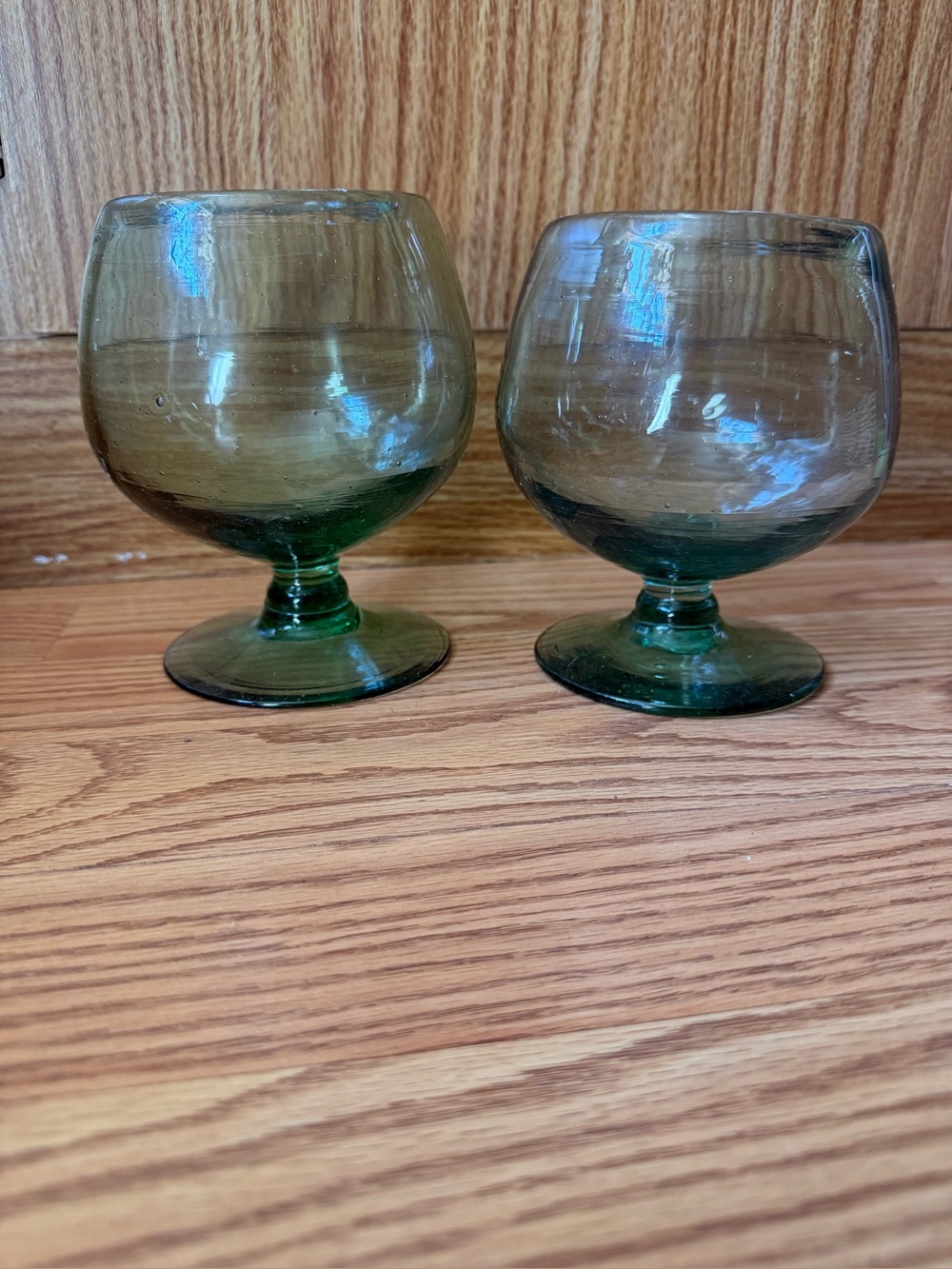 2 vintage handblown Mexican green glass goblets feature a distinct pedestal base